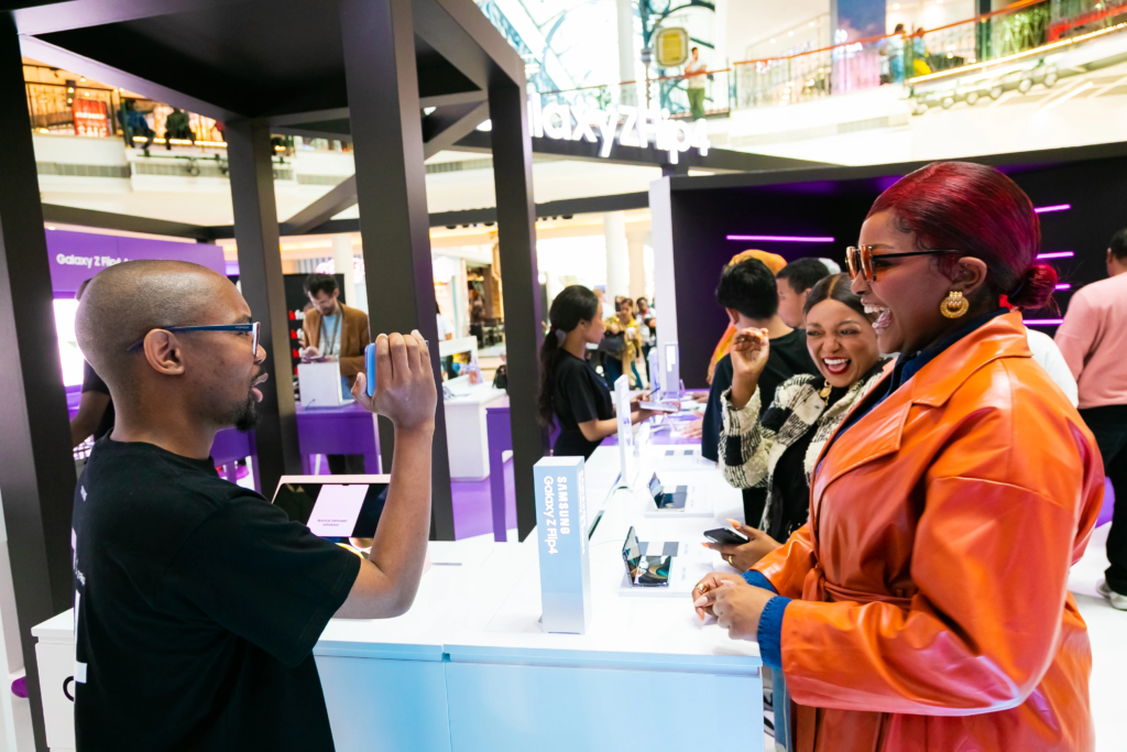 A branded event activation with people interacting with a sales representative