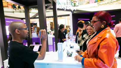 A branded event activation with people interacting with a sales representative
