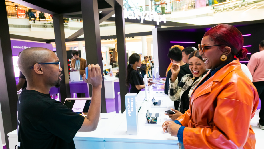 A branded event activation with people interacting with a sales representative