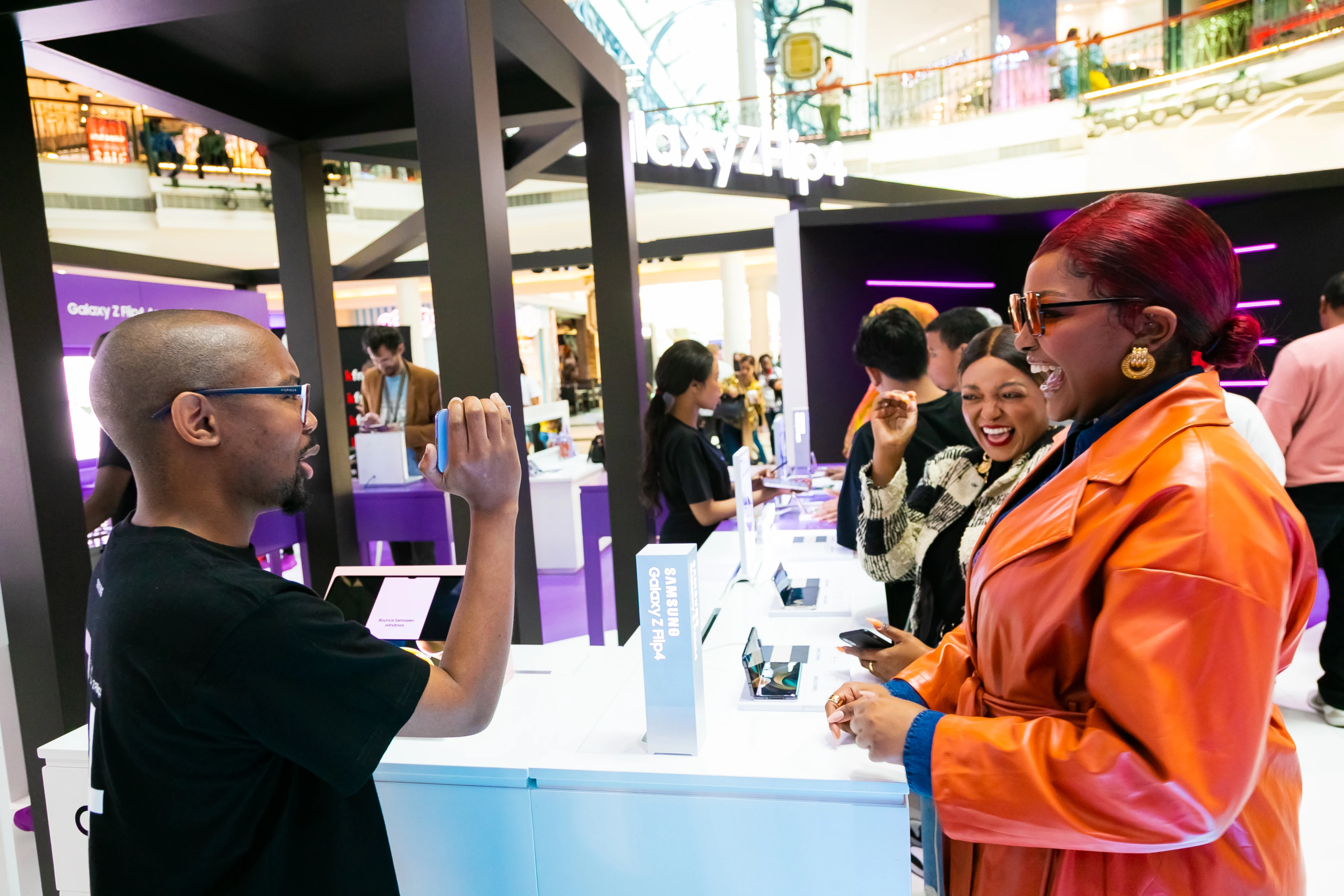 A branded event activation with people interacting with a sales representative